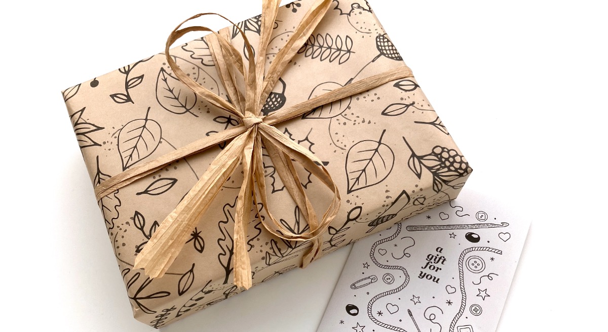 Parcel gift-wrapped in recycled kraft paper with paper ribbons