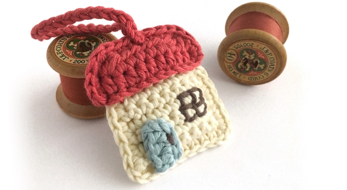 Tiny crocheted key ring in shape of cottage