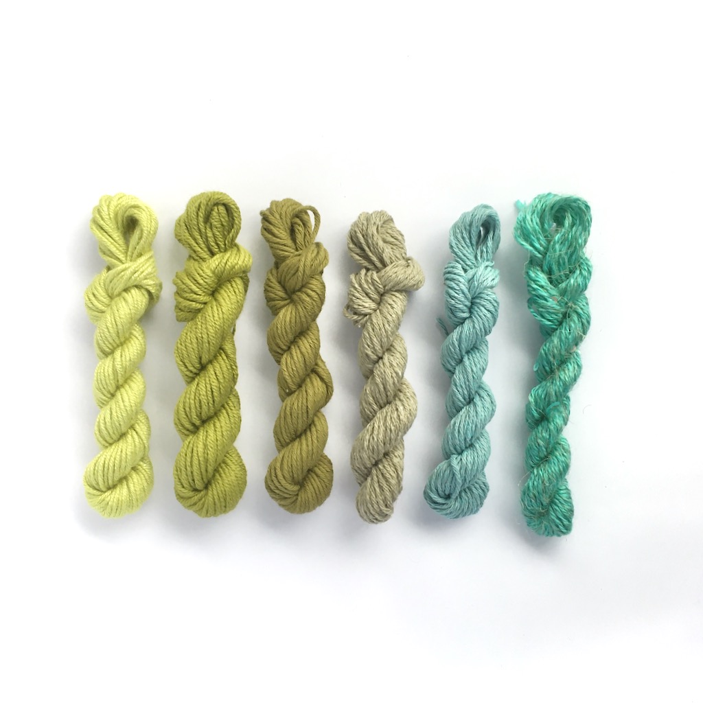 Set of mini yarn skeins is shades of green