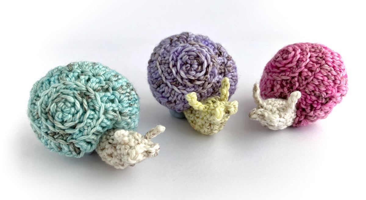 Crocheted snail in pastel colours