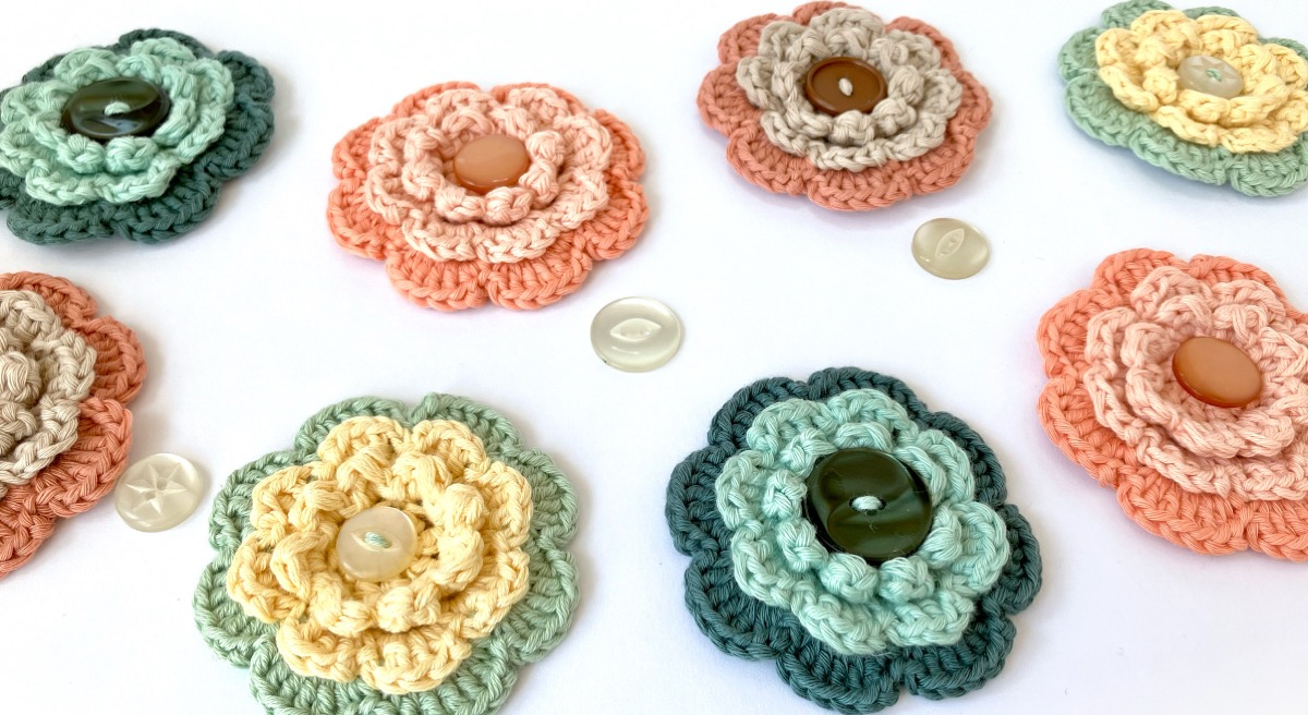 Hand-crocheted brooches with buttons from the Little Conkers Brooches with Benefits range