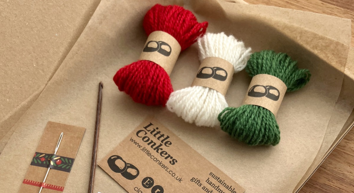 Contents of the Granny Crochet Ornaments crochet kit, including wool and crochet hook