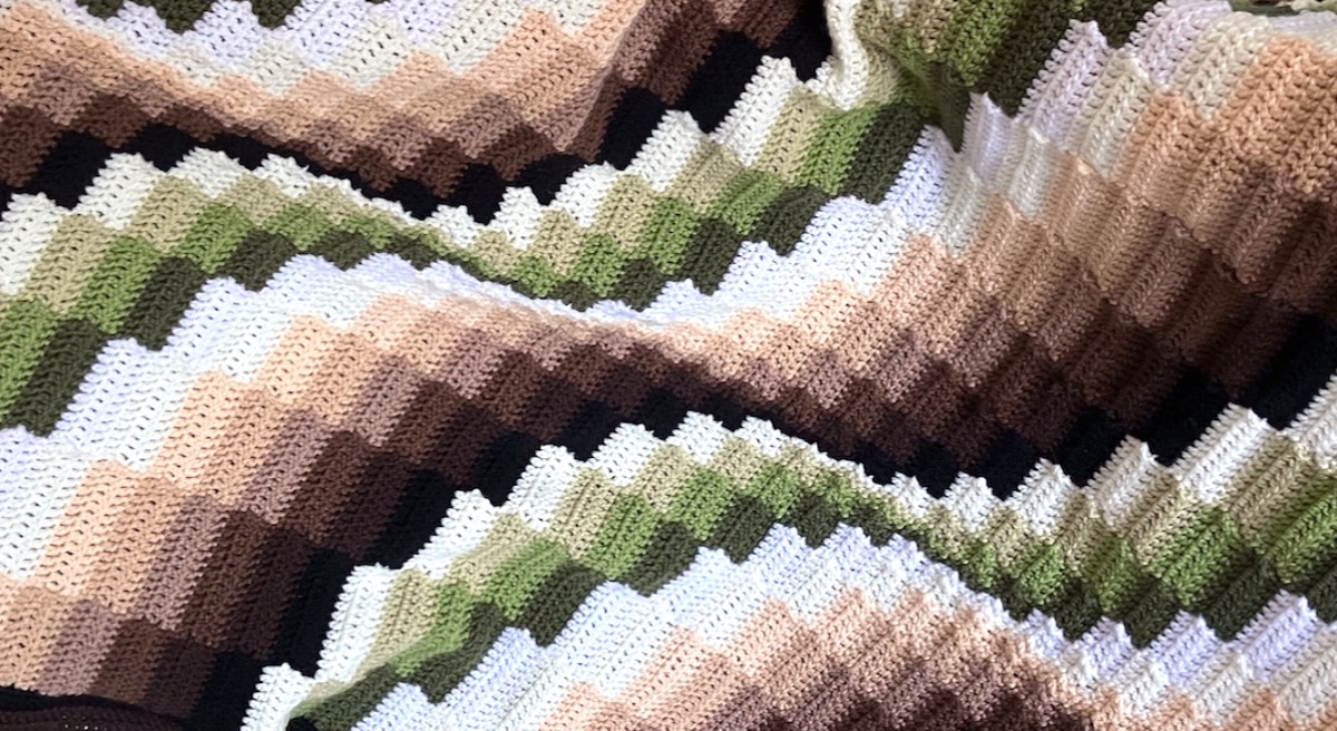 Crocheted bargello blocks style blanket in shades of green and brown