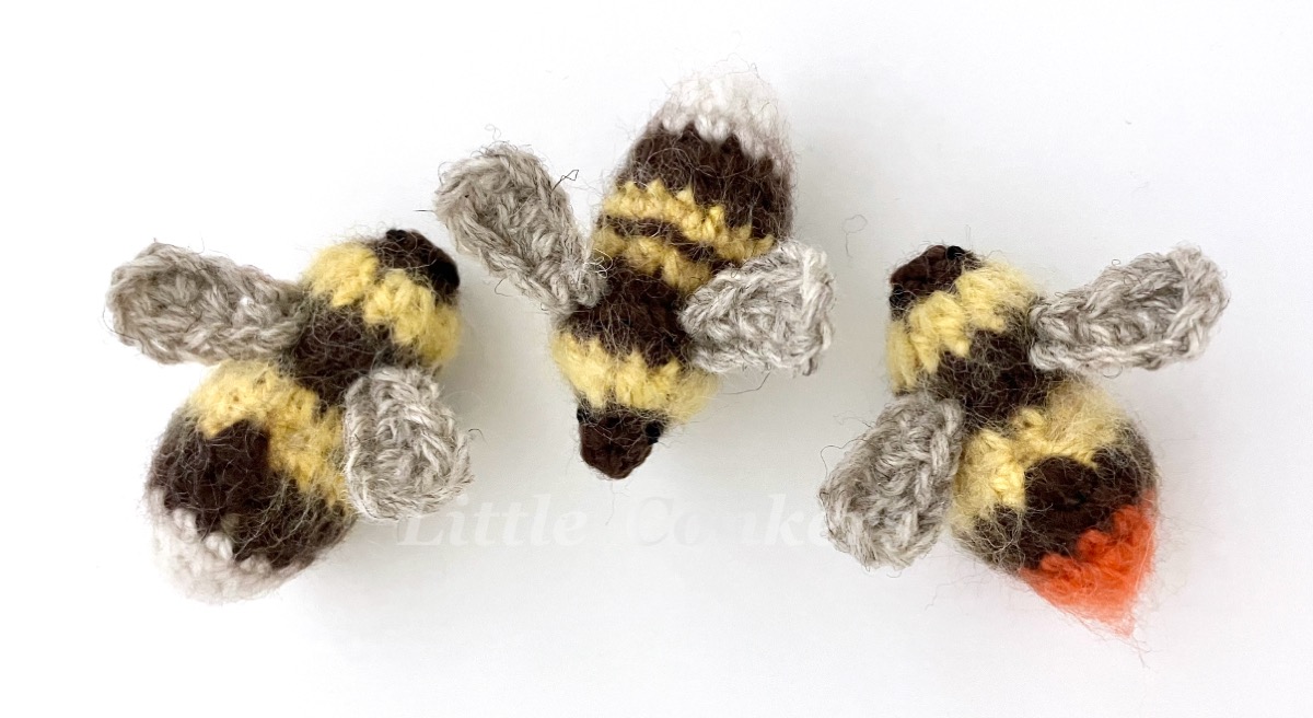 Realistic crocheted queen bumblebees of different species